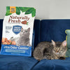 Naturally Fresh Ultra Odor Control Walnut Shell Probiotic Cat Litter with a Cat